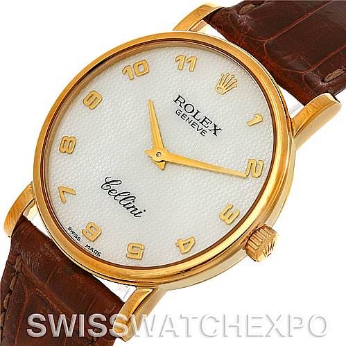 The Rolex Cellini 5115 Men's Yellow Gold Mother of Pearl Dial 5115 Men's Yellow Gold Mother of Pearl Dial watch is shown at an oblique angle displaying its face, gold accents, and part of its brown leather strap.