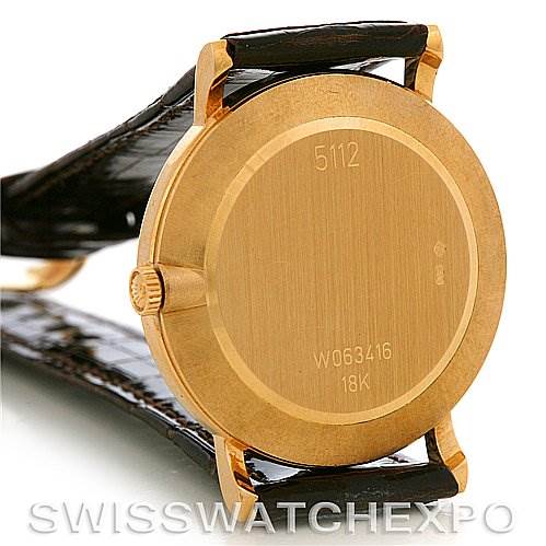 The image shows the back view of a Rolex Cellini 5112 Men's Yellow Gold White Dial 5112 Men's Yellow Gold White Dial watch, highlighting its case back and part of the leather strap.