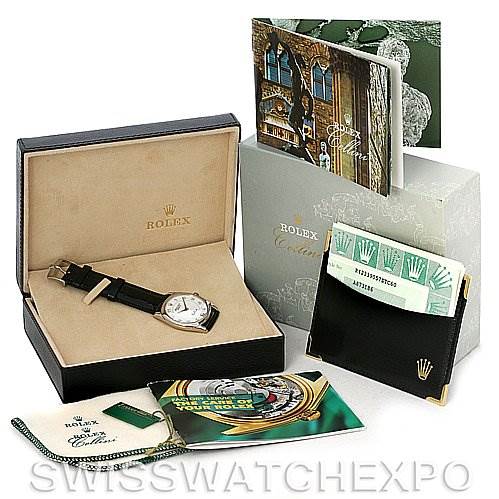 The image shows a Rolex Cellini 4233 Men's White Gold White Dial 4233 Men's White Gold White Dial watch and accessories, including the box, manuals, document holder, and a green tag.