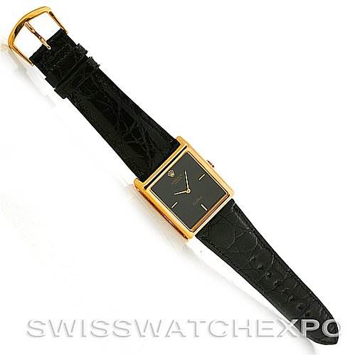 This image shows a top-down view of a Rolex Cellini 4105 Men's Yellow Gold Black Dial 4105 Men's Yellow Gold Black Dial watch with a rectangular gold case and black leather strap.