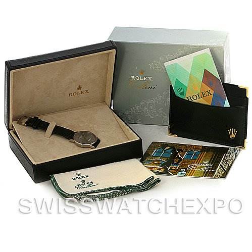 The image shows a Rolex Cellini 5115 Men's White Gold Grey Dial 5115 Men's White Gold Grey Dial watch with its box, booklet, warranty card, and cleaning cloth, displayed at an angle.