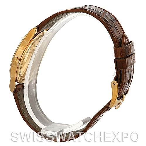 This image shows a side view of a Rolex Cellini 5116 Men's Yellow Gold Black Dial 5116 Men's Yellow Gold Black Dial watch, highlighting its gold case and brown leather strap with a gold buckle.