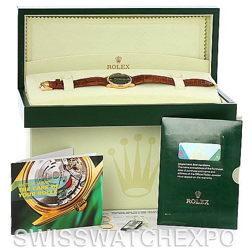 The image shows a top view of the Rolex Cellini 5116 Men's Yellow Gold Black Dial 5116 Men's Yellow Gold Black Dial watch with its box, manuals, and warranty card.