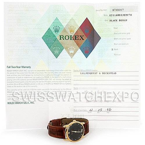 The image shows a Rolex Cellini 5116 Men's Yellow Gold Black Dial 5116 Men's Yellow Gold Black Dial watch with a brown leather strap and its warranty certificate at an angled front view.