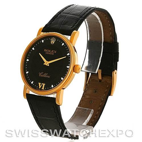 This Rolex Cellini 5115 Men's Yellow Gold Black Dial 5115 Men's Yellow Gold Black Dial watch is shown at an angle, highlighting its black dial, gold casing, and black leather strap.