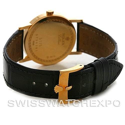 The image shows the back view of a Rolex Cellini 5115 Men's Yellow Gold Black Dial 5115 Men's Yellow Gold Black Dial watch with a black leather strap and gold buckle.