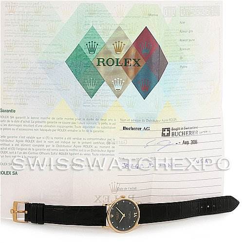 The image shows a Rolex Cellini 5115 Men's Yellow Gold Black Dial 5115 Men's Yellow Gold Black Dial watch laid flat alongside its certificate of authenticity and warranty paperwork.