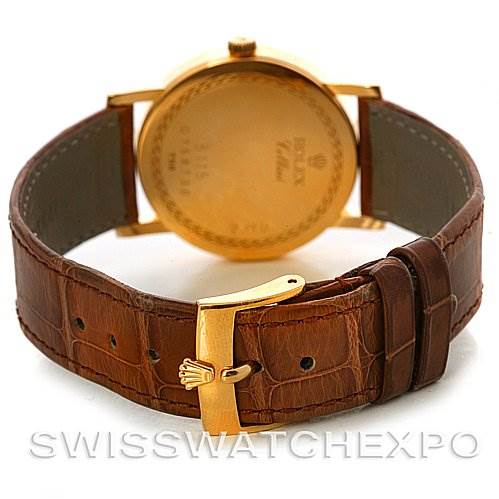 The image shows the back of a Rolex Cellini 5115 Men's Yellow Gold Beige Dial 5115 Men's Yellow Gold Beige Dial watch, highlighting the gold case and brown leather strap with a buckle.