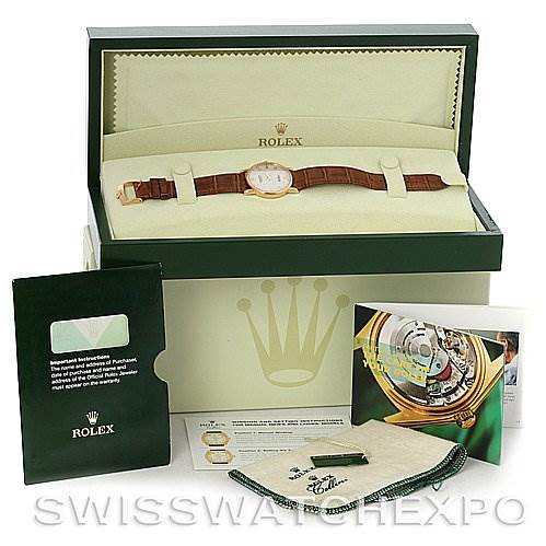 The image shows a Rolex Cellini 5115 Men's Yellow Gold Beige Dial 5115 Men's Yellow Gold Beige Dial watch in its box, with manuals, a certificate, and a cleaning cloth displayed nearby.