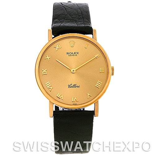This image shows a front view of a Rolex Cellini 5112 Men
s Yellow Gold Champagne Dial 5112 Men
s Yellow Gold Champagne Dial watch, featuring a gold dial with Roman numerals and a black leather strap.