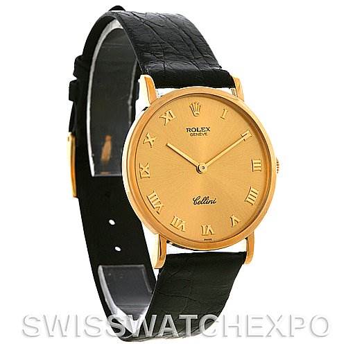 The image shows a Rolex Cellini 5112 Men
s Yellow Gold Champagne Dial 5112 Men
s Yellow Gold Champagne Dial model watch, featuring a gold case, gold Roman numeral dial, and black leather strap, at an angled side view.