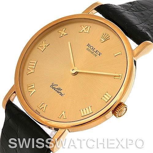 The Rolex Cellini 5112 Men
s Yellow Gold Champagne Dial 5112 Men
s Yellow Gold Champagne Dial watch is shown from an angled view, highlighting its gold case, Roman numeral dial, and black leather strap.