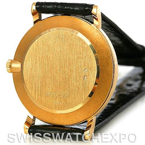 This image shows the back case of a Rolex Cellini 5112 Men
s Yellow Gold Champagne Dial 5112 Men
s Yellow Gold Champagne Dial watch, showcasing its gold casing and black leather strap.