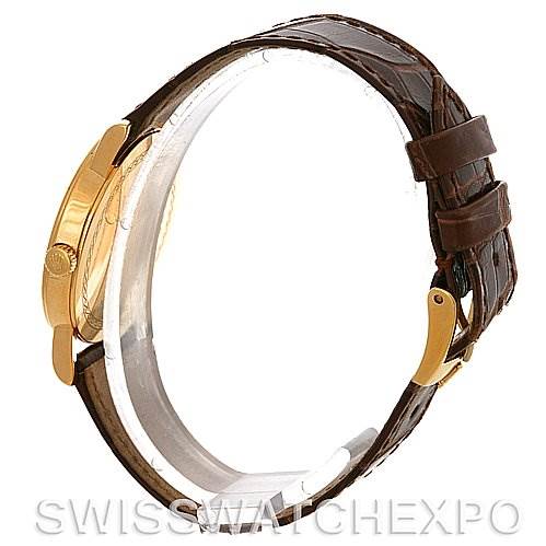 This image shows a Rolex Cellini 5115 Men's Yellow Gold Silver Dial 5115 Men's Yellow Gold Silver Dial model watch from a side view, highlighting its gold case and brown leather strap.