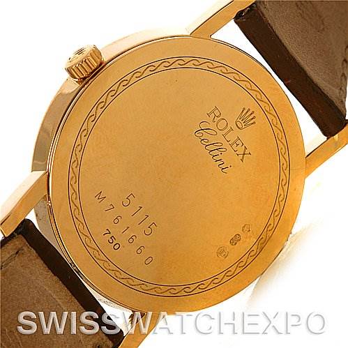 The image shows the back case of a Rolex Cellini 5115 Men's Yellow Gold Silver Dial 5115 Men's Yellow Gold Silver Dial watch, featuring engraving details and a leather strap attachment.