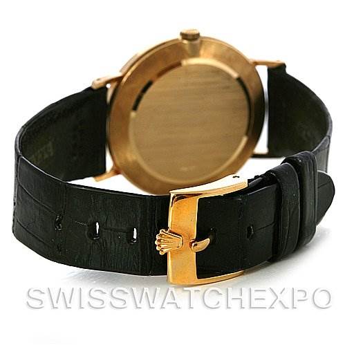 The image shows the Rolex Cellini 4112 Yellow Gold White Dial 4112 Yellow Gold White Dial watch from a rear angle, highlighting the case back and the clasp on the leather strap.