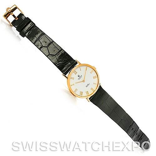 This image shows a top-down view of a Rolex Cellini 4112 Yellow Gold White Dial 4112 Yellow Gold White Dial watch, displaying the face, Roman numeral markers, and black leather strap.