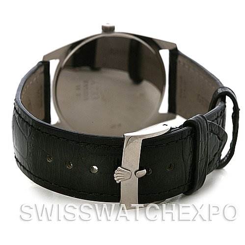 The image shows the back view of a Rolex Cellini 4233 Men's White Gold Black Dial 4233 Men's White Gold Black Dial watch, highlighting its leather strap and clasp with the brand's logo.