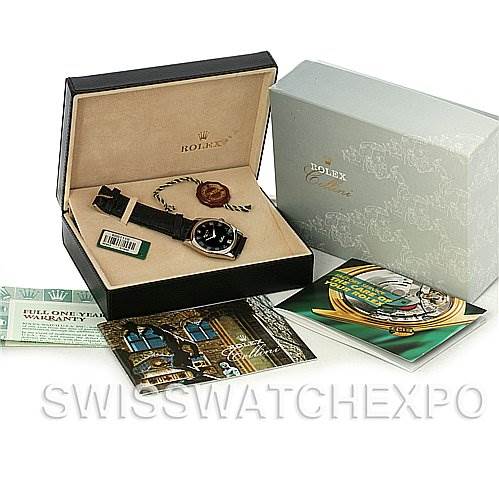 The image shows a Rolex Cellini 4233 Men's White Gold Black Dial 4233 Men's White Gold Black Dial watch angled from the top, alongside its box, warranty card, and booklets.