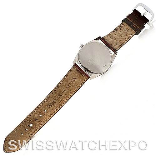 The image shows the back view of a Rolex Cellini 4233 Men
s White Gold Black Dial 4233 Men
s White Gold Black Dial watch with its brown leather strap extended.