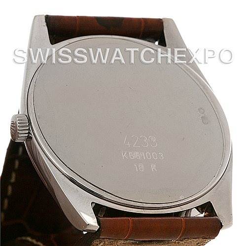 The image shows the back case of the Rolex Cellini 4233 Men
s White Gold Black Dial 4233 Men
s White Gold Black Dial watch displaying its model number and 18k marking.