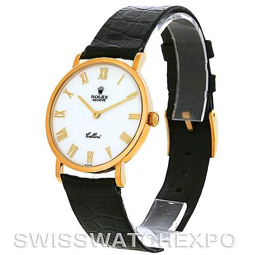 The Rolex Cellini 5112 Men's Yellow Gold White Dial 5112 Men's Yellow Gold White Dial watch is shown at an angle highlighting its face with Roman numerals, gold case, crown, and black leather strap.