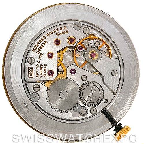 The image shows the internal mechanism of a Rolex Cellini 5112 Men's Yellow Gold White Dial 5112 Men's Yellow Gold White Dial model watch, featuring gears, jewels, and the balance wheel.