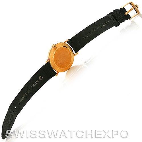 The image shows the back view of a Rolex Cellini 5112 Men's Yellow Gold White Dial 5112 Men's Yellow Gold White Dial watch with a black leather strap and gold buckle.