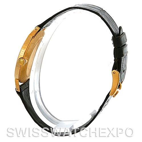 The image shows a side view of a Rolex Cellini 4112 Yellow Gold White Dial 4112 Yellow Gold White Dial watch, highlighting its gold case, crown, and black leather strap.