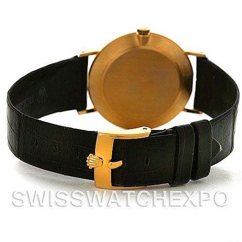 The image shows the back view of a Rolex Cellini 4112 Yellow Gold White Dial 4112 Yellow Gold White Dial watch, highlighting its leather strap, buckle, and the gold case back.