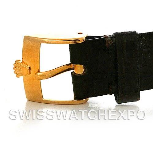 This image shows a close-up of the gold buckle and black leather strap of a Rolex Cellini 4112 Yellow Gold White Dial 4112 Yellow Gold White Dial watch.