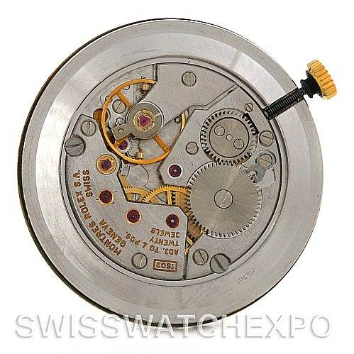 This image shows the internal mechanics of a Rolex Cellini 4112 Yellow Gold White Dial 4112 Yellow Gold White Dial watch, featuring gears and other intricate components from a top-down angle.