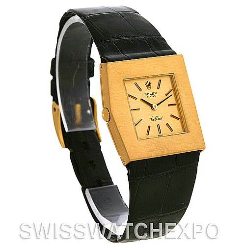 The Rolex Cellini 4017 Men
s Yellow Gold Champagne Dial 4017 Men
s Yellow Gold Champagne Dial watch is shown at an angled side view, highlighting its square gold face and black leather strap.