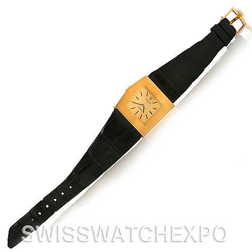 The image shows a Rolex Cellini 4017 Men
s Yellow Gold Champagne Dial 4017 Men
s Yellow Gold Champagne Dial watch with a gold rectangular face and a black leather strap, viewed from a top-down angle.