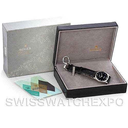 The image shows a Rolex Cellini 4233 Men's White Gold Black Dial 4233 Men's White Gold Black Dial watch in an open display box, alongside the outer packaging and accompanying documents.