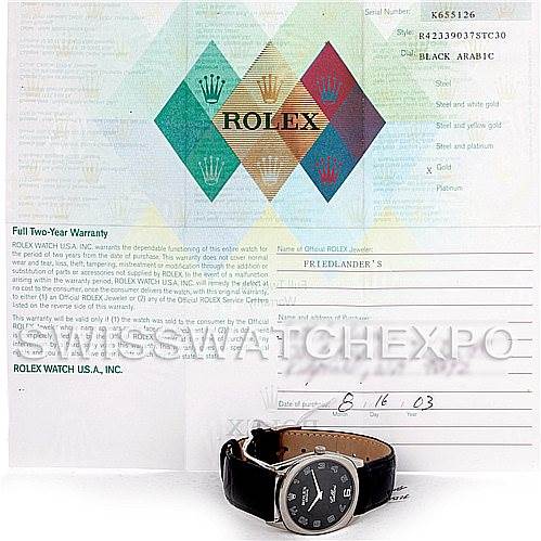 The image shows a Rolex Cellini 4233 Men's White Gold Black Dial 4233 Men's White Gold Black Dial watch with a black strap, accompanied by its warranty card and paperwork viewed from the front.