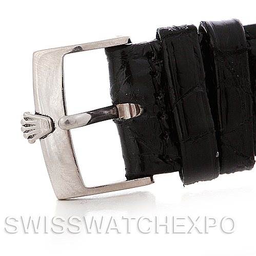 The image shows a close-up of the buckle and black leather strap of a Rolex Cellini 4233 Men
s White Gold White Dial 4233 Men
s White Gold White Dial watch.