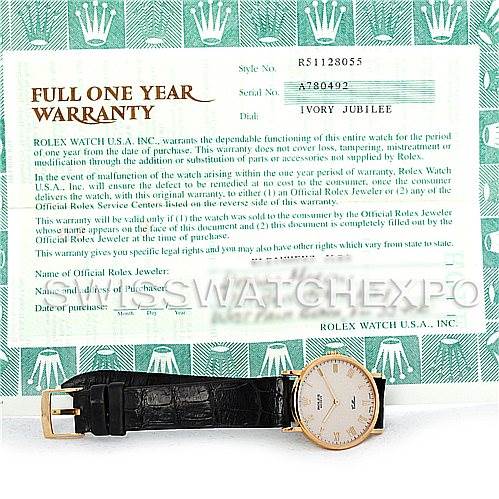 The image shows a Rolex Cellini 5112 Men's Yellow Gold Beige Dial 5112 Men's Yellow Gold Beige Dial watch laid flat with its face visible, accompanied by a warranty card in the background.