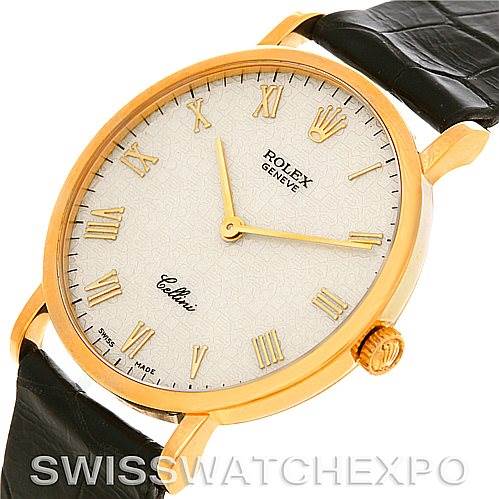 This image shows a close-up, angled view of the Rolex Cellini 5112 Men's Yellow Gold Beige Dial 5112 Men's Yellow Gold Beige Dial watch, highlighting its face, gold casing, crown, and black leather strap.