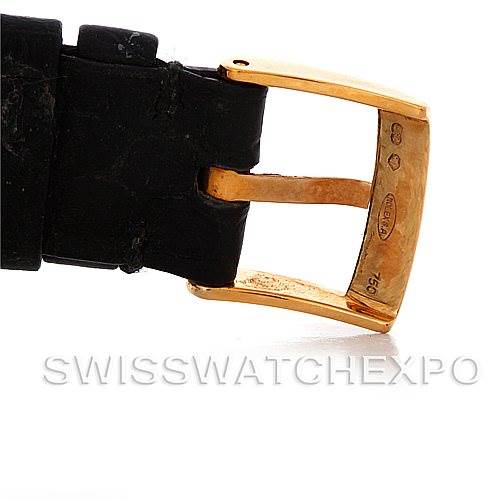 This image shows the gold buckle and part of the black strap of a Rolex Cellini 5112 Men's Yellow Gold Beige Dial 5112 Men's Yellow Gold Beige Dial watch.