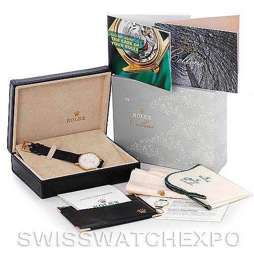 The image shows a Rolex Cellini 5112 Men's Yellow Gold Beige Dial 5112 Men's Yellow Gold Beige Dial watch at a slight angle in its box along with accessories and documents, including manuals and warranty cards.