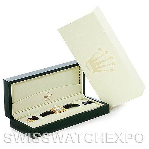 The image shows a Rolex Cellini 5330 Men
s Yellow Gold White Dial 5330 Men
s Yellow Gold White Dial watch in a partially opened box, displaying the watch horizontally with the strap visible and the lid leaning nearby.