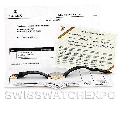 The image shows a Rolex Cellini 5116 Men
s Yellow Gold Grey Dial 5116 Men
s Yellow Gold Grey Dial watch laid flat with documentation and warranty papers, viewed from above.