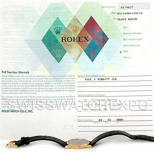 The image shows a Rolex Cellini 5116 Men
s Yellow Gold Grey Dial 5116 Men
s Yellow Gold Grey Dial watch with a leather strap and its warranty certificate.