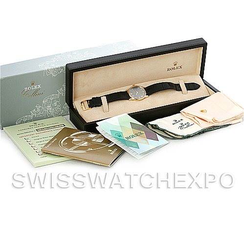 The image shows a Rolex Cellini 5116 Men
s Yellow Gold Grey Dial 5116 Men
s Yellow Gold Grey Dial watch along with its box, manuals, warranty card, and cleaning cloth from a top-down angle.