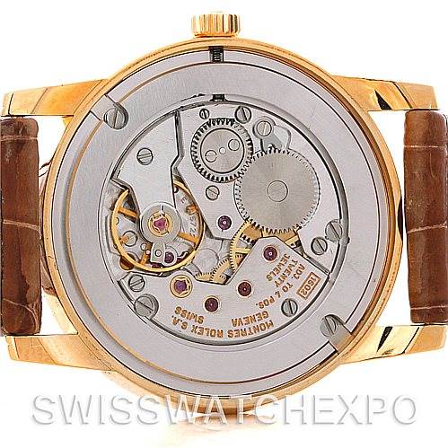 The image shows the rear view of a Rolex Cellini 5116 Men's Yellow Gold Mother of Pearl Dial 5116 Men's Yellow Gold Mother of Pearl Dial watch, highlighting its intricate internal movement mechanism.