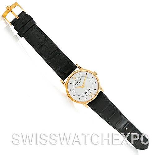 The image shows a top-down view of a Rolex Cellini 5116 Men's Yellow Gold Silver Dial 5116 Men's Yellow Gold Silver Dial watch with a black leather strap and a gold case.