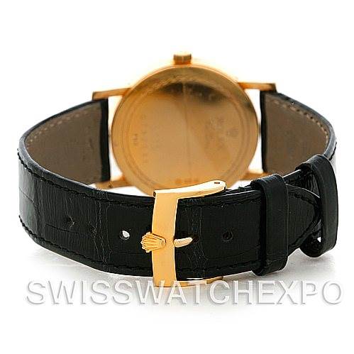 The image shows a rear view of a Rolex Cellini 5115 Men's Yellow Gold Black Dial 5115 Men's Yellow Gold Black Dial with its black leather strap and a gold clasp.