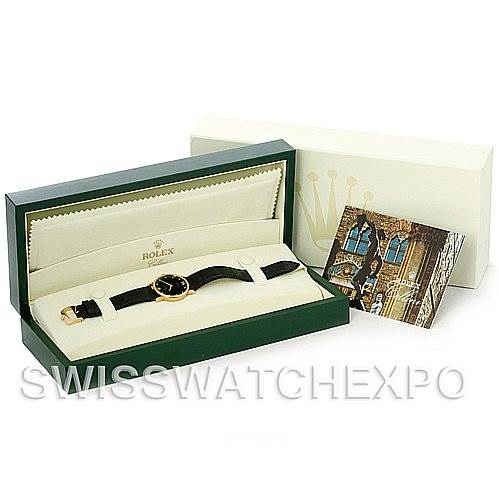 The image shows a Rolex Cellini 5115 Men's Yellow Gold Black Dial 5115 Men's Yellow Gold Black Dial model watch in its open green box, along with a booklet and outer packaging.