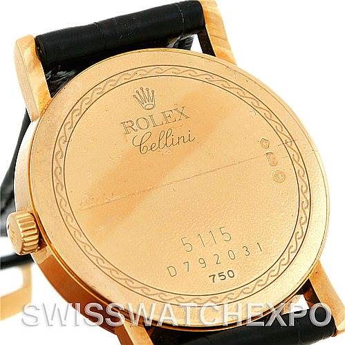 This image shows the back case of a Rolex Cellini 5115 Men's Yellow Gold Black Dial 5115 Men's Yellow Gold Black Dial watch from an angled view, with visible markings and part of the leather strap.